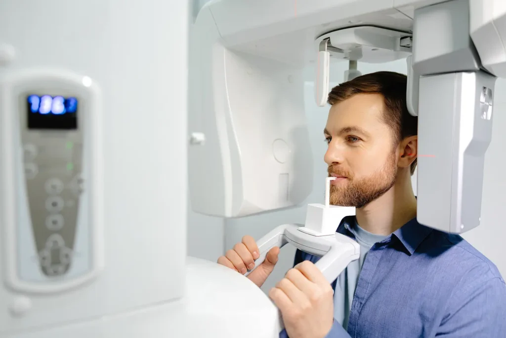 Patient is getting panoramic X-rays from Parkway Family Dental